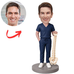 Chiropractor in Blue Scrubs Holding Spine Model Custom Bobblehead