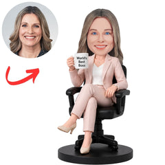 Seated Female Boss in Pink Suit Holding a World's Best Boss Mug Custom Bobblehead